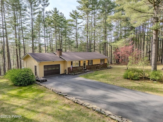 117 Circle Dr, Hawley, PA 18428 - single story home featuring covered porch, a chimney, a front yard, a garage, and aphalt driveway