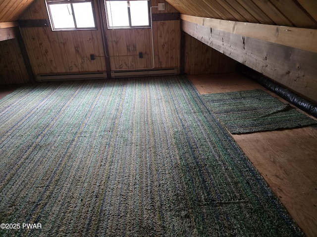 bonus room with wood walls, lofted ceiling, and a wealth of natural light
