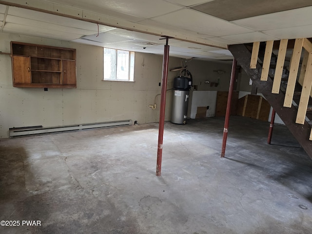 below grade area featuring stairway, water heater, and a baseboard radiator