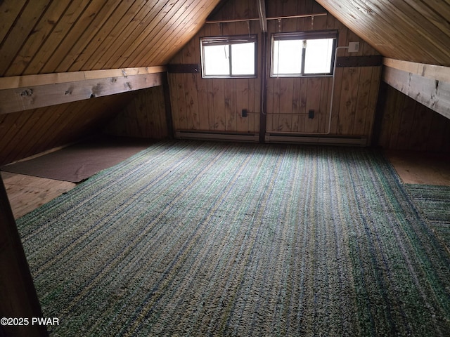 additional living space featuring wooden walls, carpet floors, a baseboard heating unit, and lofted ceiling