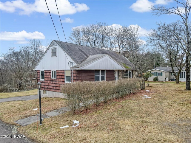 view of side of home featuring a lawn