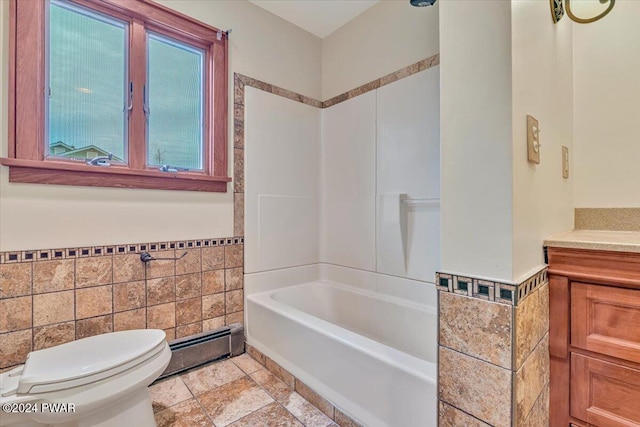 full bathroom featuring vanity, a baseboard radiator, toilet, and tile walls