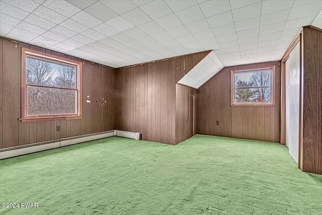 bonus room featuring a baseboard radiator, light colored carpet, and wood walls