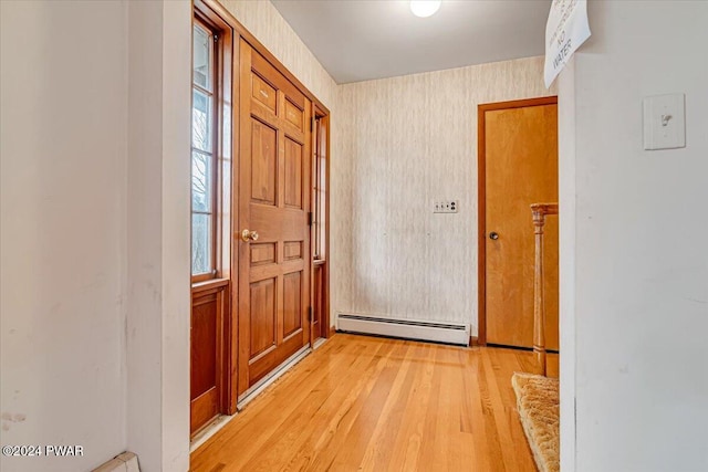 entryway featuring a baseboard radiator and light hardwood / wood-style flooring