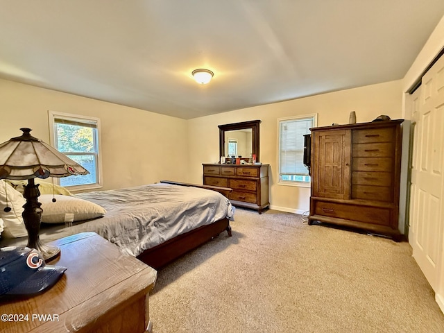 carpeted bedroom with a closet