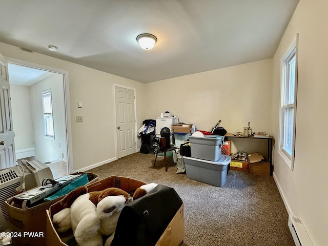 misc room featuring carpet and a baseboard heating unit