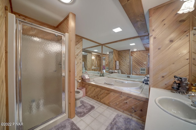 full bathroom with vanity, wood walls, tile patterned floors, toilet, and shower with separate bathtub