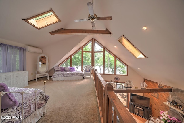 carpeted bedroom featuring a wall mounted air conditioner, ceiling fan, wood walls, and vaulted ceiling with skylight