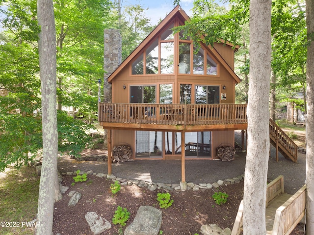 rear view of property featuring a deck