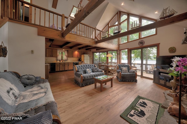 living room featuring light wood-type flooring and a towering ceiling