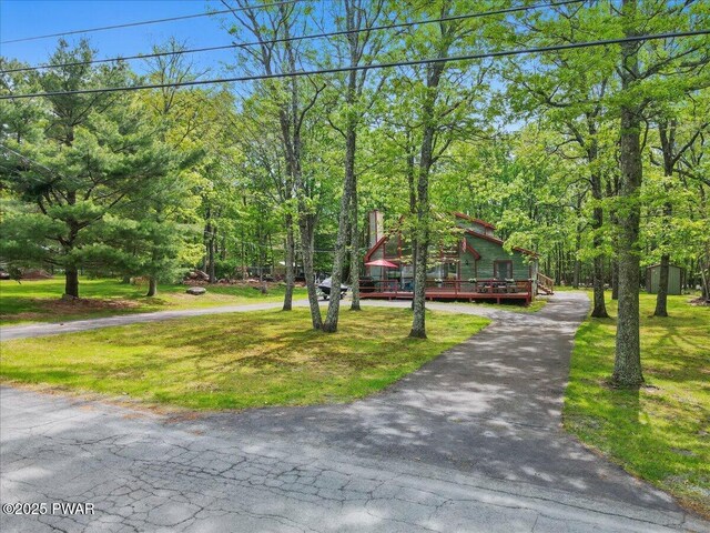 173 Paper Birch S, Tafton, PA 18464 - view of front of home featuring asphalt driveway, a front lawn, and a wooden deck