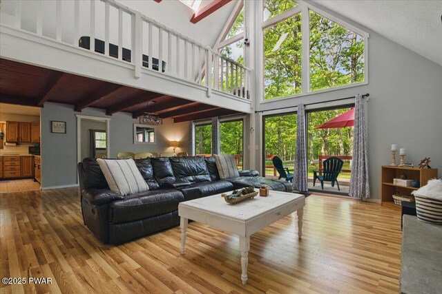 173 Paper Birch S, Tafton, PA 18464 - living area with light wood-type flooring, plenty of natural light, beamed ceiling, high vaulted ceiling, and a skylight