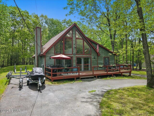 173 Paper Birch S, Tafton, PA 18464 - rear view of house with a wooden deck, asphalt driveway, and a chimney