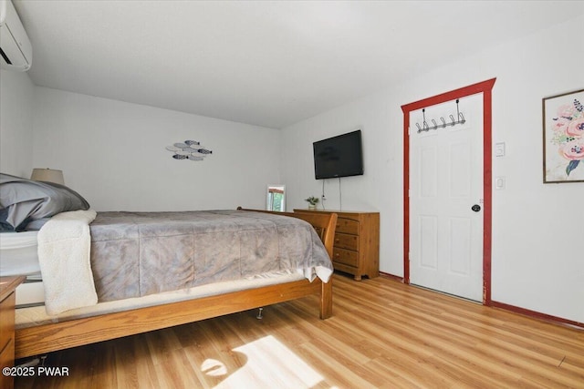 173 Paper Birch S, Tafton, PA 18464 - bedroom with an AC wall unit, light wood finished floors, and baseboards