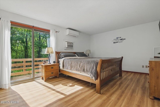 173 Paper Birch S, Tafton, PA 18464 - bedroom with a wall unit AC, access to outside, and light wood-style floors
