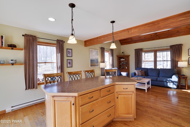 kitchen with plenty of natural light, light brown cabinets, light wood-style floors, and a baseboard radiator