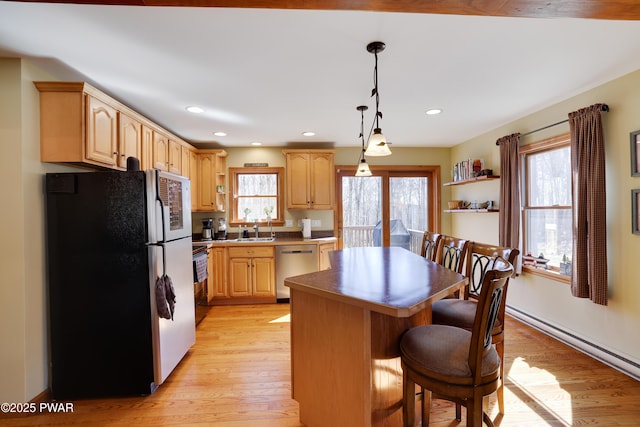 kitchen with open shelves, light wood-type flooring, a kitchen island, and appliances with stainless steel finishes