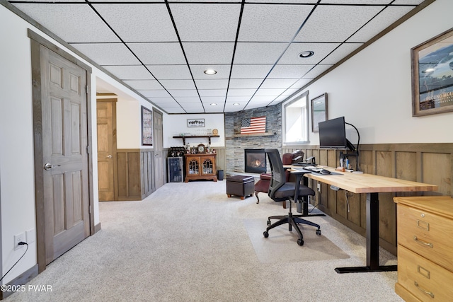 carpeted office space featuring a drop ceiling, a wainscoted wall, and recessed lighting