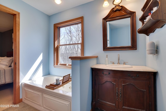 ensuite bathroom with vanity, a bath, and ensuite bathroom