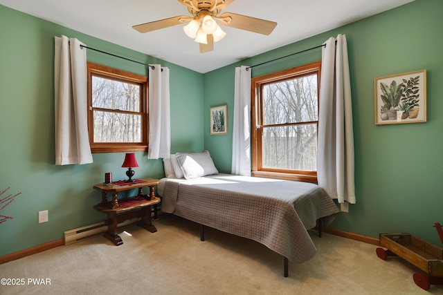 bedroom with ceiling fan, baseboards, and carpet