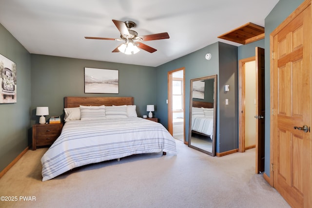 bedroom with a ceiling fan, light colored carpet, and baseboards