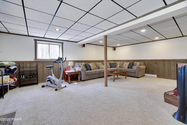 living room featuring a wainscoted wall, a drop ceiling, recessed lighting, wooden walls, and carpet flooring