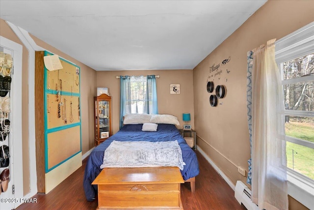 bedroom featuring baseboards and wood finished floors
