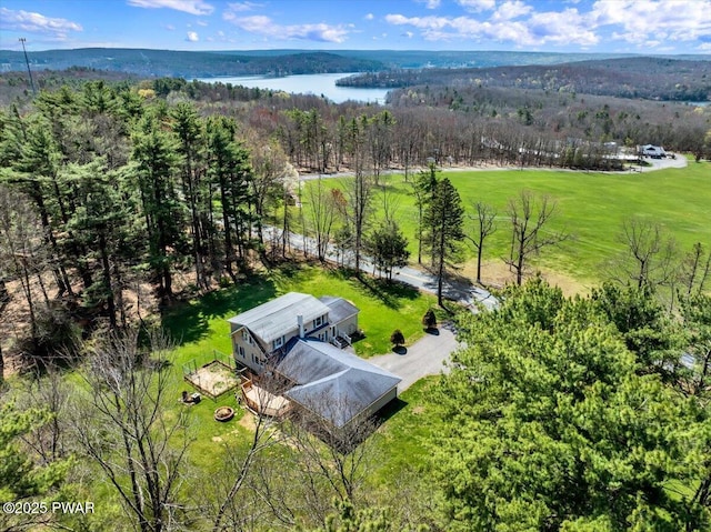 aerial view featuring a water view and a wooded view