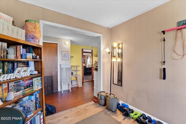 interior space with crown molding and wood finished floors