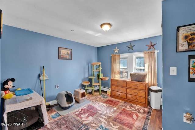 bedroom with baseboards and wood finished floors