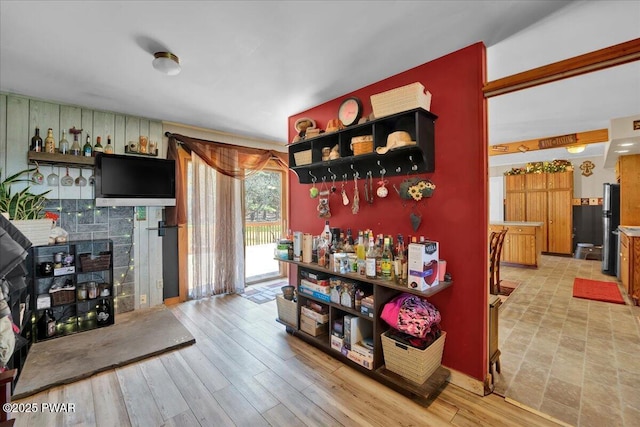 interior space featuring light wood-type flooring and a fireplace with raised hearth