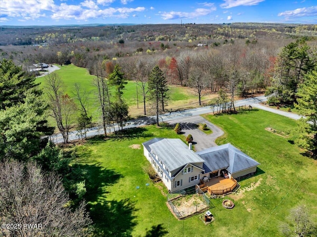 drone / aerial view with a wooded view
