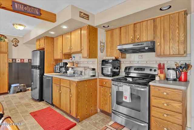 kitchen featuring decorative backsplash, light countertops, under cabinet range hood, a sink, and stainless steel appliances