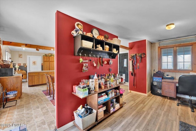 interior space with baseboards and light wood-type flooring