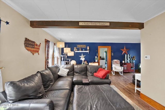 living room featuring ornamental molding, beamed ceiling, and wood finished floors