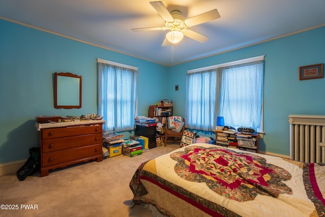 bedroom featuring carpet flooring, ceiling fan, and crown molding