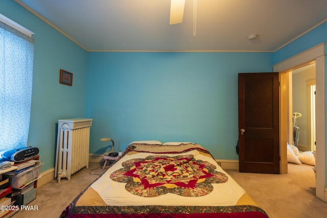 carpeted bedroom with radiator heating unit and ceiling fan