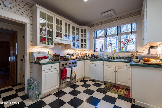 kitchen with stainless steel range, backsplash, white cabinetry, and dishwasher