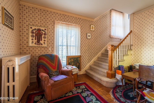 living area with parquet floors and ornamental molding