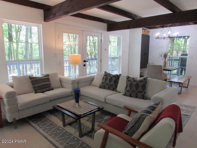 living room with french doors, an inviting chandelier, and beam ceiling