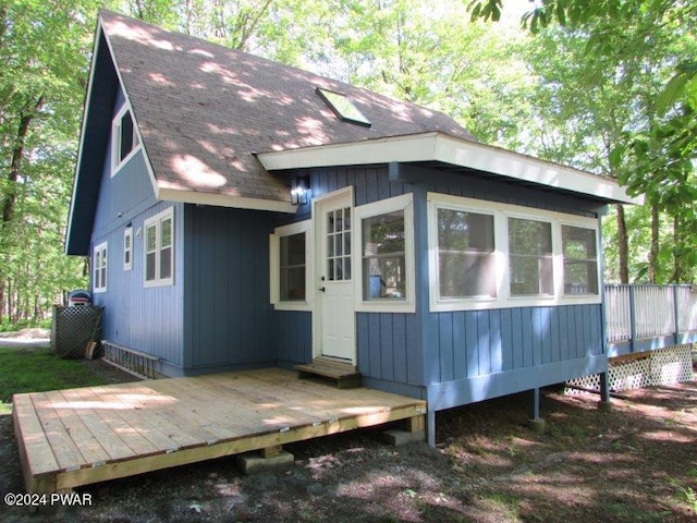 back of house featuring a wooden deck