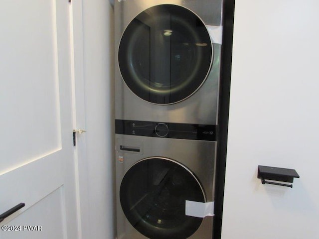 washroom featuring stacked washer / drying machine