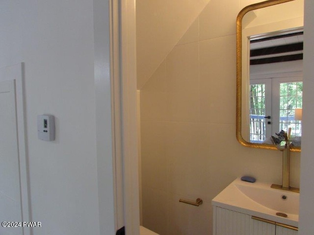 bathroom featuring french doors and vanity