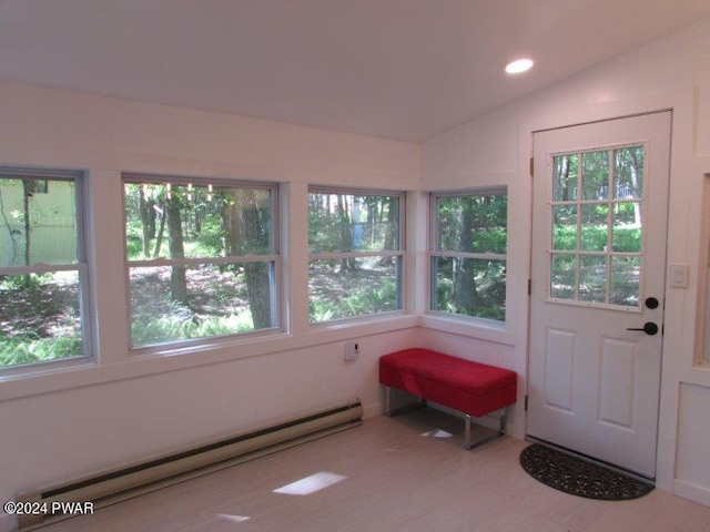 entryway featuring lofted ceiling and a baseboard heating unit