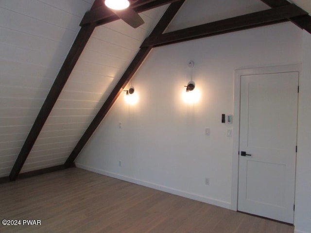 bonus room with vaulted ceiling with beams, wood ceiling, and light wood-type flooring