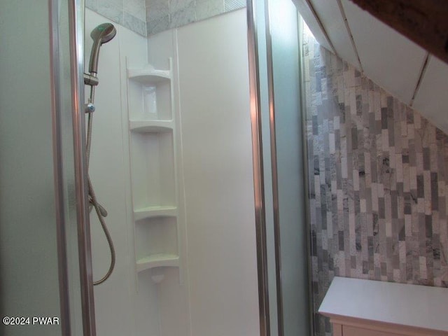 bathroom featuring vaulted ceiling and walk in shower