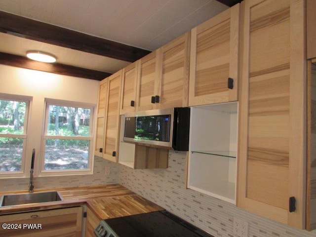 kitchen featuring tasteful backsplash, sink, light brown cabinets, and wood counters