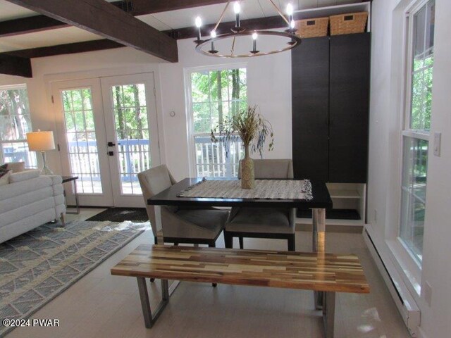 dining area with beam ceiling, an inviting chandelier, and french doors