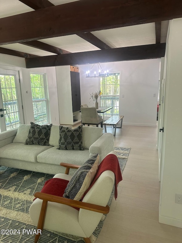 living room featuring a chandelier, beam ceiling, and light hardwood / wood-style floors