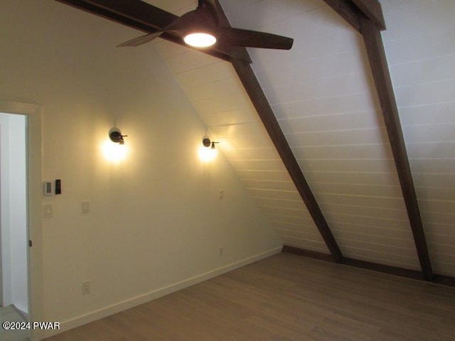 interior space with ceiling fan, wood-type flooring, and lofted ceiling